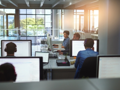 Image of a group of people working on computers in an office