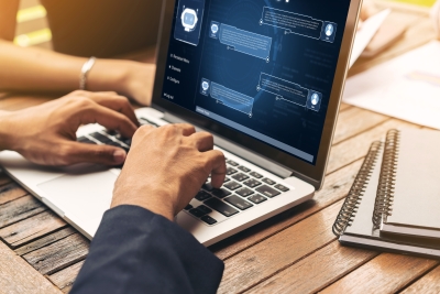 Image showing a person typing on a laptop and chatting with an AI assistant